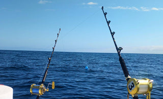 Heavy-duty deep sea fishing rod with reel on a boat deck